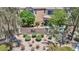 A well-maintained neighborhood entrance featuring lush landscaping, brick walls, and mature trees at 10692 Tulip Valley Rd, Las Vegas, NV 89179