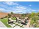 Charming backyard with outdoor seating area, green grass, and beautiful landscaping at 10836 Montana Blanca Ave, Las Vegas, NV 89166