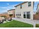 Backyard features the exterior of the home, grass, seating area, and brick pavers at 10836 Montana Blanca Ave, Las Vegas, NV 89166