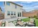 Backyard featuring a patio with chairs, grass, and a sliding glass door to the home at 10836 Montana Blanca Ave, Las Vegas, NV 89166