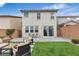 Backyard features grass, seating area, exterior of the home and brick walls at 10836 Montana Blanca Ave, Las Vegas, NV 89166