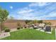 Inviting backyard with seating area, green lawn, and well-maintained landscaping at 10836 Montana Blanca Ave, Las Vegas, NV 89166