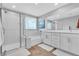 Bright bathroom featuring double vanity, walk-in shower, and a soaking tub at 10836 Montana Blanca Ave, Las Vegas, NV 89166