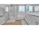 Bright bathroom featuring double vanity, walk-in shower, and a soaking tub at 10836 Montana Blanca Ave, Las Vegas, NV 89166