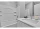 Bright bathroom with a shower-tub combo, a neutral color palette, and a modern vanity at 10836 Montana Blanca Ave, Las Vegas, NV 89166