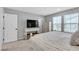 Bright bedroom featuring a comfy bed, dresser, console table, and natural light at 10836 Montana Blanca Ave, Las Vegas, NV 89166