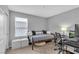 Neutral bedroom features a comfortable daybed, work desk, and bright natural light at 10836 Montana Blanca Ave, Las Vegas, NV 89166