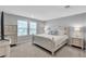 Spacious bedroom featuring a king-size bed, dresser, bedside tables, and neutral color palette at 10836 Montana Blanca Ave, Las Vegas, NV 89166