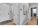 Bright entryway features wood-look floors, white doors, and modern artwork at 10836 Montana Blanca Ave, Las Vegas, NV 89166