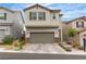 Inviting two-story home with a two-car garage and charming desert landscaping, enhancing curb appeal at 10836 Montana Blanca Ave, Las Vegas, NV 89166