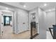 Hallway features carpeted floor, double door closet, laundry area and bedroom access at 10836 Montana Blanca Ave, Las Vegas, NV 89166