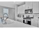 Well-equipped kitchen with white cabinets, stainless steel appliances, and a stylish backsplash for modern appeal at 10836 Montana Blanca Ave, Las Vegas, NV 89166