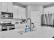 Bright kitchen with quartz countertop, stainless steel appliances and ample counter space at 10836 Montana Blanca Ave, Las Vegas, NV 89166