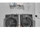 Laundry room featuring a washer, dryer, and storage shelf at 10836 Montana Blanca Ave, Las Vegas, NV 89166