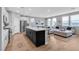 Open-concept living space connects a modern kitchen island to the naturally lit living room at 10836 Montana Blanca Ave, Las Vegas, NV 89166