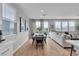 Open-concept living and dining area with hardwood floors and lots of natural light at 10836 Montana Blanca Ave, Las Vegas, NV 89166