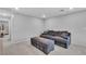 Upstairs loft area with comfortable gray sofa, ottoman and carpeted floors at 10836 Montana Blanca Ave, Las Vegas, NV 89166