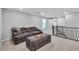 Upstairs loft area featuring comfortable seating, a cozy ottoman, and a view of the staircase at 10836 Montana Blanca Ave, Las Vegas, NV 89166