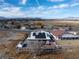 Expansive aerial view of a desert community featuring modern solar panels on the house's roof at 1261 S Comstock St, Pahrump, NV 89048