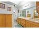 Bright bathroom with double sinks, tile flooring, ample cabinet space and a large mirror at 1261 S Comstock St, Pahrump, NV 89048