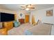 This bedroom features carpeted floors, TV, sitting chair, and neutral paint at 1261 S Comstock St, Pahrump, NV 89048