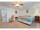 This bedroom boasts carpeted floors, rocking chair, ceiling fan, and neutral paint at 1261 S Comstock St, Pahrump, NV 89048
