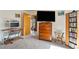 Bedroom featuring carpet flooring, a wooden dresser and media cabinet, and a work desk at 1261 S Comstock St, Pahrump, NV 89048