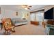 This bedroom features carpeted floors, ceiling fan, rocking chair and a comfy bed at 1261 S Comstock St, Pahrump, NV 89048