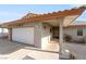 Charming home exterior featuring a single-car garage, covered entry, and desert landscaping at 1261 S Comstock St, Pahrump, NV 89048