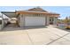 Home with a two-car garage and large driveway at 1261 S Comstock St, Pahrump, NV 89048