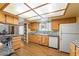 Traditional kitchen with wood cabinets, granite counters, a window, and plank flooring at 1261 S Comstock St, Pahrump, NV 89048
