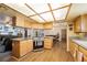 Open kitchen view with light wood cabinets, stone countertops, and stainless steel appliances at 1261 S Comstock St, Pahrump, NV 89048