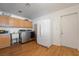 Functional laundry room with modern washer and dryer, utility sink, and ample cabinet space at 1261 S Comstock St, Pahrump, NV 89048