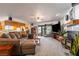 Living room featuring carpet, ceiling fan and view to the kitchen at 1261 S Comstock St, Pahrump, NV 89048
