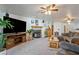 Spacious living room with fireplace, ceiling fans, entertainment center, and plush seating at 1261 S Comstock St, Pahrump, NV 89048