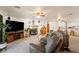 Open-concept living room with fireplace, ceiling fan, and plush, comfortable seating at 1261 S Comstock St, Pahrump, NV 89048