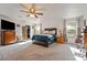 Bright and spacious main bedroom with a ceiling fan, closet, and carpet flooring at 1261 S Comstock St, Pahrump, NV 89048