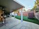 Inviting backyard features artificial turf, covered patio with outdoor seating, and a tall block wall at 1482 Flintrock Rd, Henderson, NV 89014