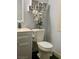Cozy half-bathroom features modern decor, white fixtures, and stylish shelving for added storage at 1482 Flintrock Rd, Henderson, NV 89014