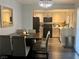 Bright dining area and connected kitchen with stainless steel appliances and a stylish chandelier at 1482 Flintrock Rd, Henderson, NV 89014