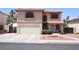 Charming two-story stucco home featuring a two-car garage, red tile roof, and drought-tolerant landscaping at 1482 Flintrock Rd, Henderson, NV 89014