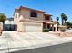 Two-story stucco house featuring an attached two-car garage, drought-tolerant landscaping, and a red tile roof at 1482 Flintrock Rd, Henderson, NV 89014