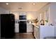 Well-lit kitchen featuring white cabinets, stainless steel appliances, and wood-look flooring at 1482 Flintrock Rd, Henderson, NV 89014