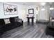 Open-concept living room featuring gray flooring, neutral walls, and a sleek console table by the entry at 1482 Flintrock Rd, Henderson, NV 89014