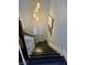Staircase featuring gray wood stairs, white trim, and a modern light fixture at the landing at 1482 Flintrock Rd, Henderson, NV 89014