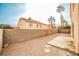 Backyard with desert landscape and tall stucco block fence provides a secluded, private outdoor area at 1604 Tamborine Ct, Las Vegas, NV 89128