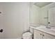 Clean half bathroom featuring a white vanity with a sink and a toilet with a white tank at 1604 Tamborine Ct, Las Vegas, NV 89128