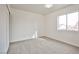 Bedroom boasts natural light from a large window, neutral carpeting, and a closet for storage at 1604 Tamborine Ct, Las Vegas, NV 89128