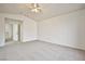 Neutral bedroom with ceiling fan, view, and access to other rooms at 1604 Tamborine Ct, Las Vegas, NV 89128