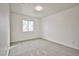 An empty bedroom featuring plush carpets, light colored walls, and a window for natural light at 1604 Tamborine Ct, Las Vegas, NV 89128
